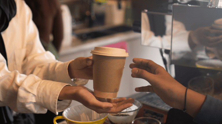Barista handing over a drink